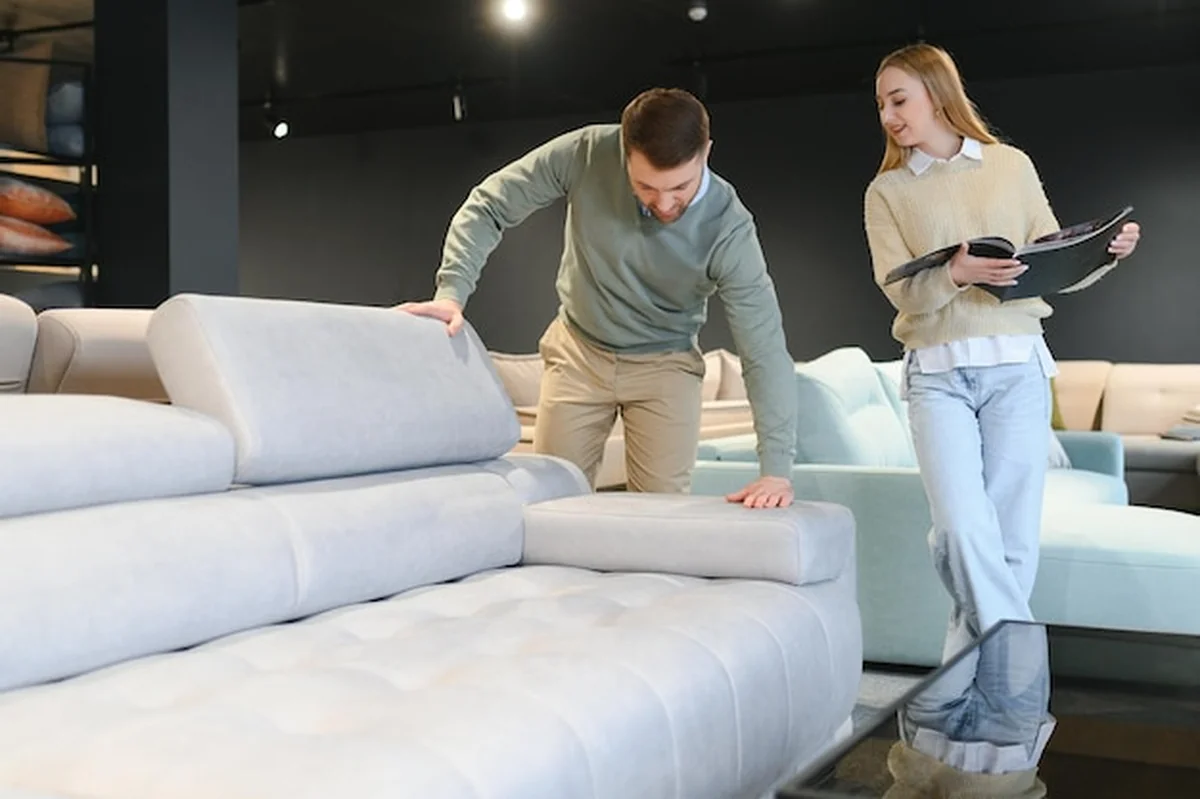 Para wybierająca kanapę w sklepie meblowym