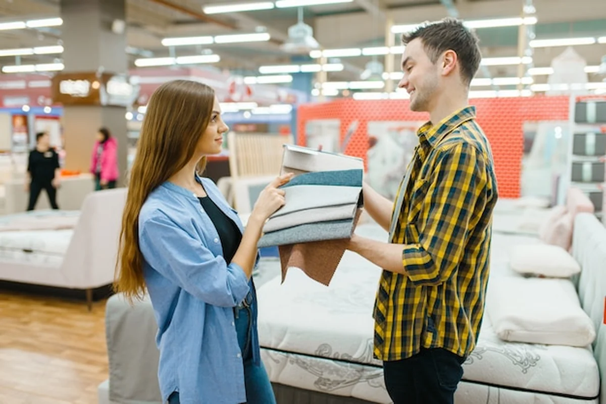 Para wybierająca materac w sklepie meblowym
