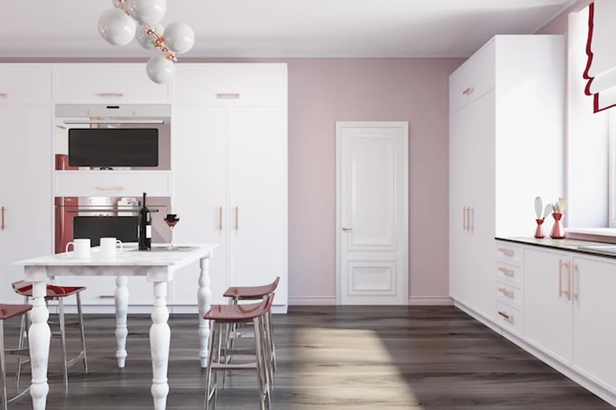 Luksusowe wnętrze kuchni z drewnianą podłogą, białymi blatami, marmurowym stołem i czerwonymi krzesłami